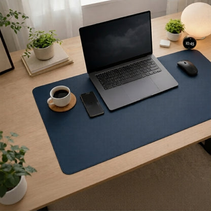 Deep blue desk mat on a minimalist workspace with laptop, mouse and coffee cup